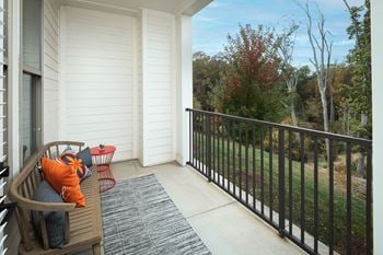 Private balcony with railing and tree views